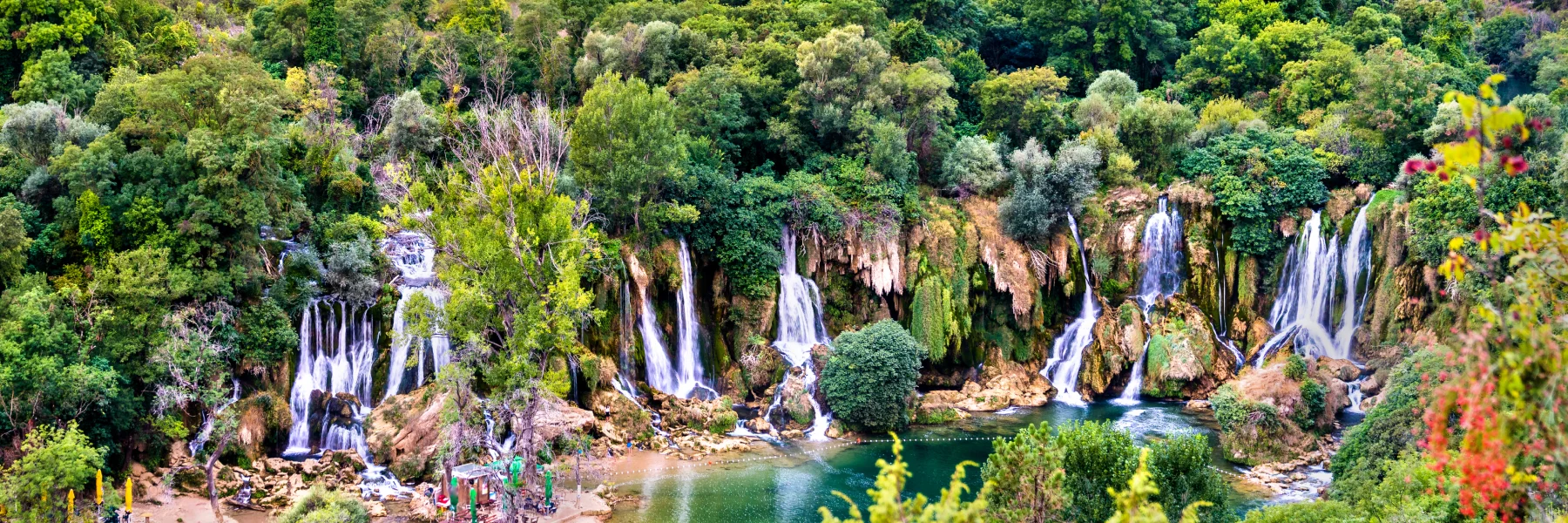 Visit Kravice Waterfalls in Bosnia, a breathtaking natural wonder with cascading turquoise waters
